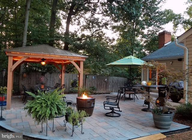 view of patio / terrace featuring a fire pit and a gazebo