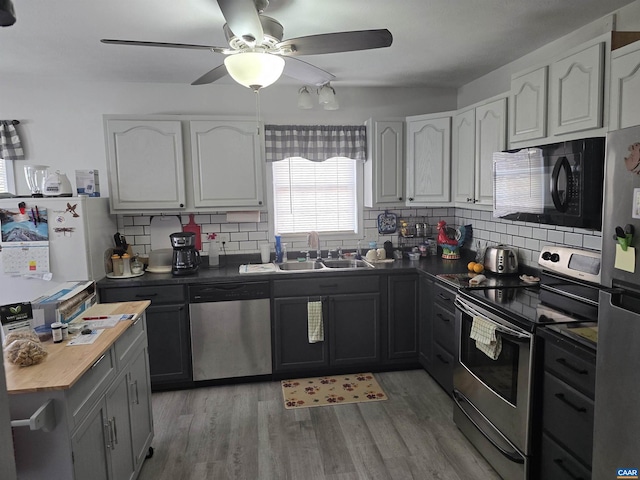 kitchen featuring white cabinetry, sink, stainless steel appliances, and light hardwood / wood-style floors