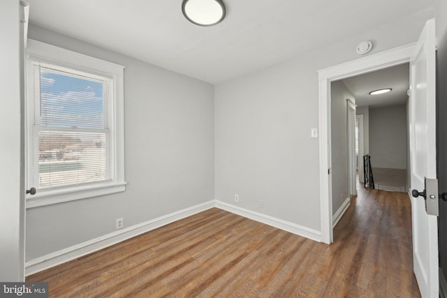 unfurnished room featuring dark hardwood / wood-style flooring