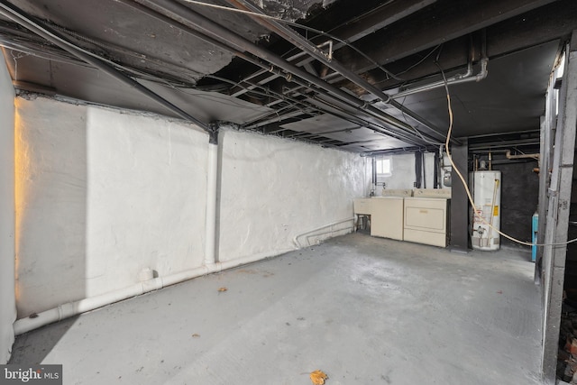 basement featuring water heater and washing machine and clothes dryer