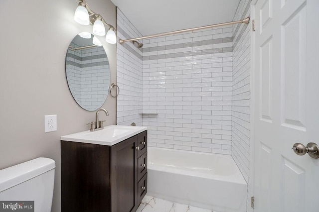 full bathroom featuring vanity, toilet, and tiled shower / bath