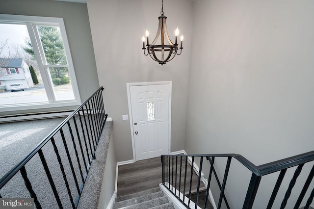 entrance foyer featuring dark hardwood / wood-style floors and a notable chandelier