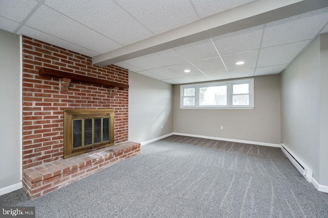 unfurnished living room featuring a paneled ceiling, a fireplace, carpet, and baseboard heating