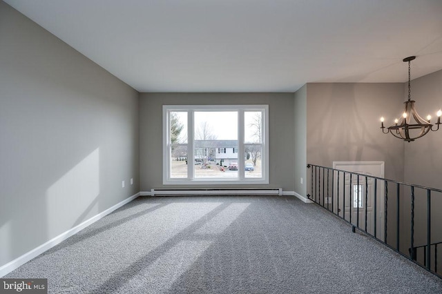 carpeted spare room with baseboard heating and a notable chandelier