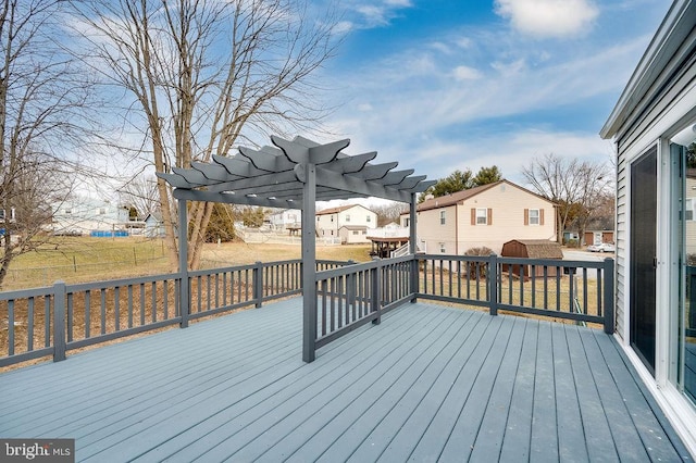 wooden deck featuring a yard and a pergola