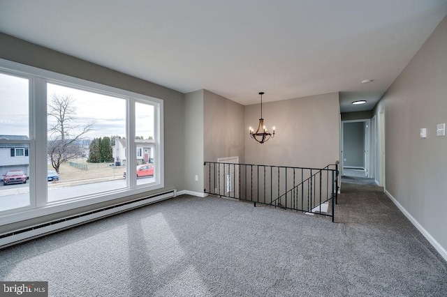 unfurnished room with an inviting chandelier, carpet, and a baseboard heating unit