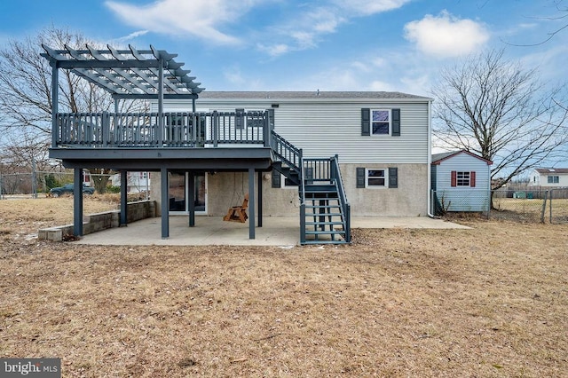 back of house featuring a pergola, a shed, a deck, and a patio area