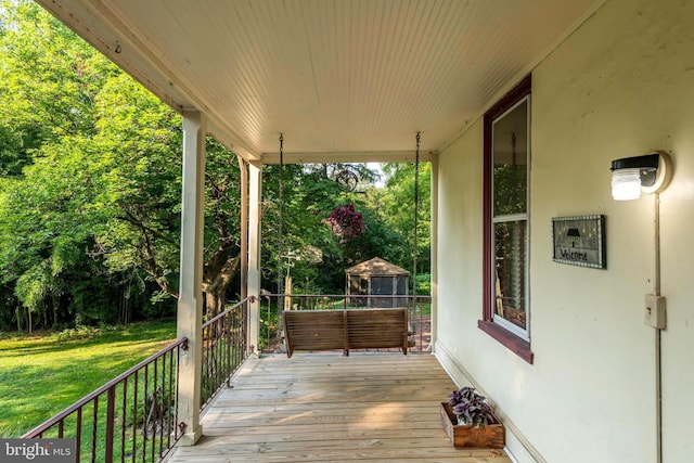 deck featuring a gazebo, a yard, and covered porch