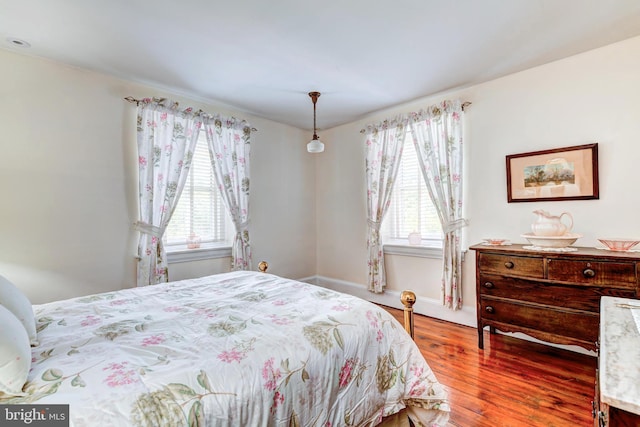 bedroom with hardwood / wood-style flooring