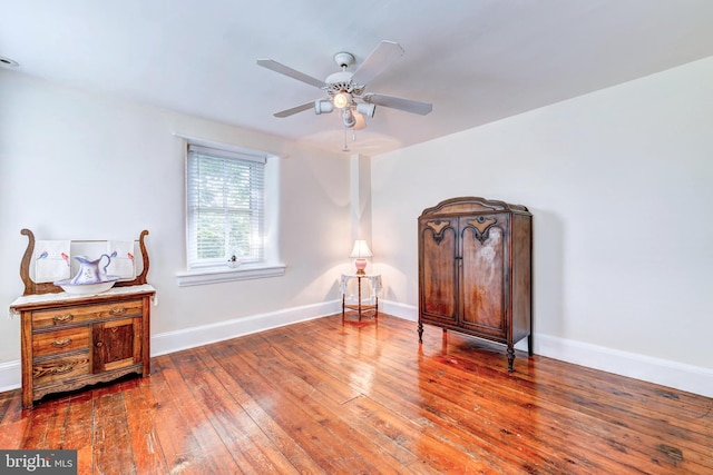 sitting room with hardwood / wood-style flooring and ceiling fan