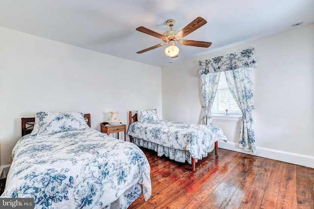 bedroom with dark hardwood / wood-style floors and ceiling fan