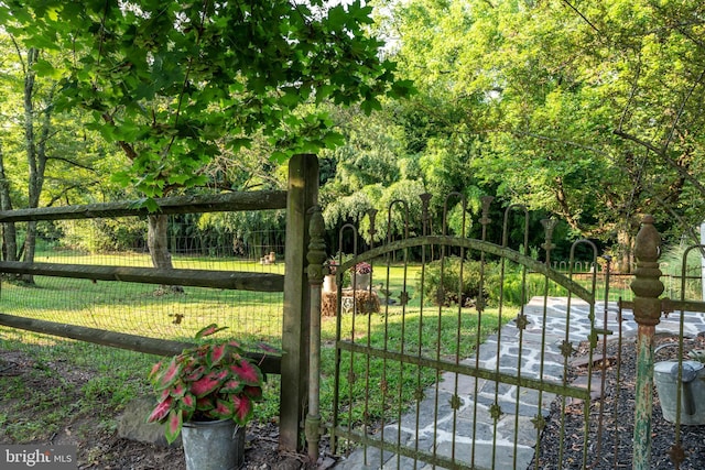 view of gate featuring a lawn