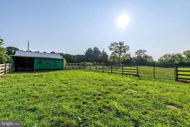 view of yard with an outbuilding and a rural view