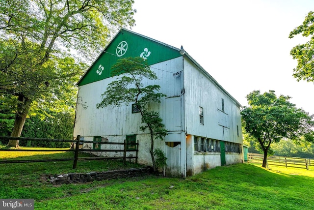 view of outbuilding featuring a lawn