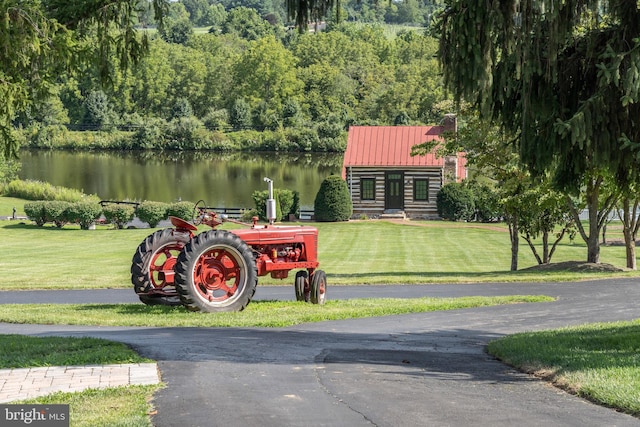 view of property's community featuring a yard and a water view