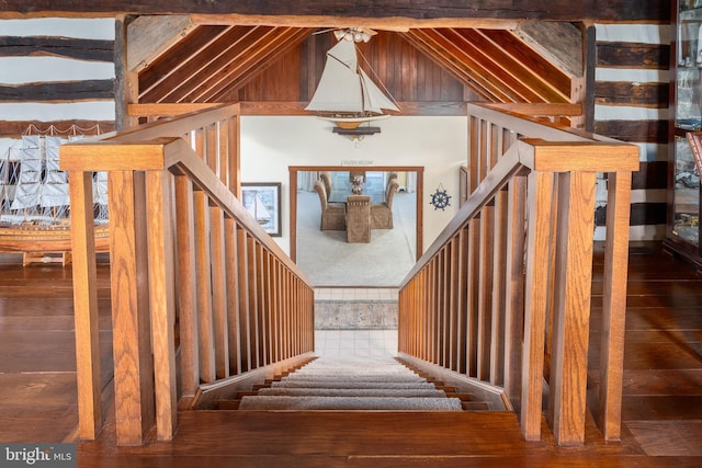 staircase with lofted ceiling and wood-type flooring