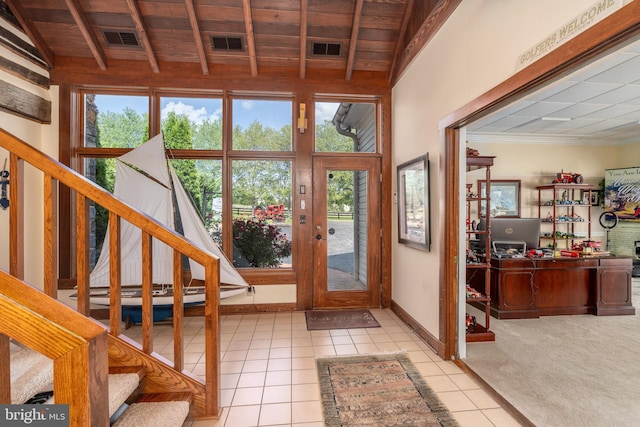 foyer entrance with light tile patterned flooring and a wealth of natural light