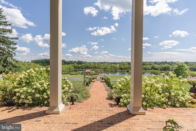 view of patio with a water view