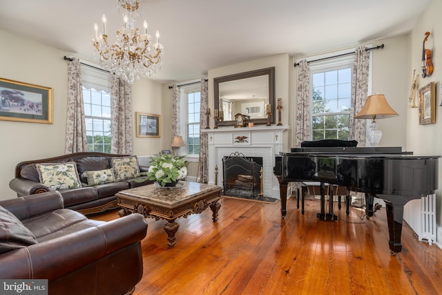 living room featuring hardwood / wood-style flooring, a fireplace, and a healthy amount of sunlight