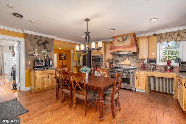 dining area with radiator, crown molding, and light hardwood / wood-style flooring