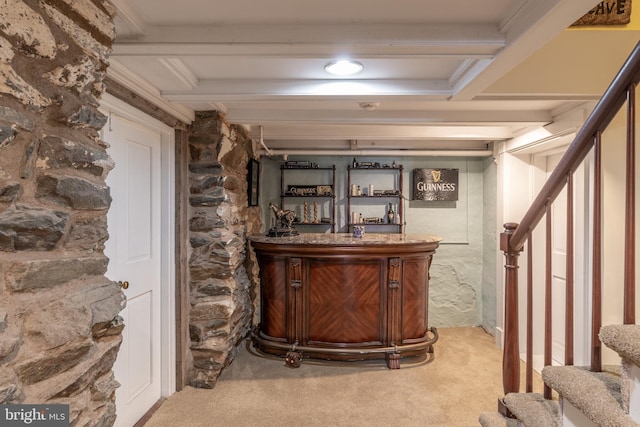 bar with carpet floors and beam ceiling