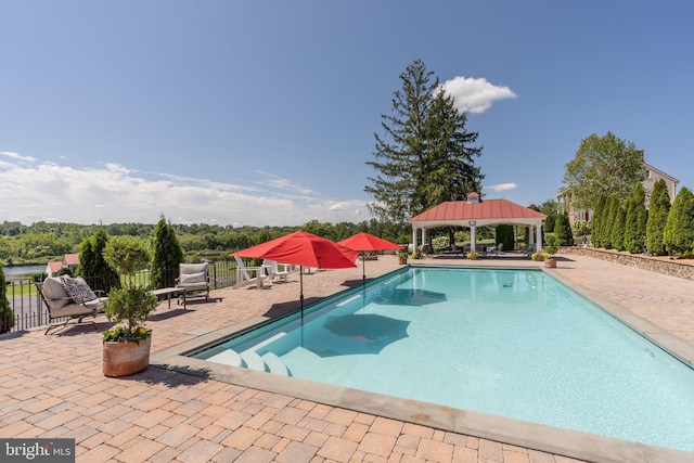 view of swimming pool featuring a gazebo and a patio area