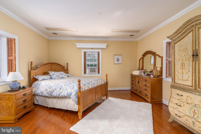 bedroom with crown molding, wood-type flooring, and cooling unit