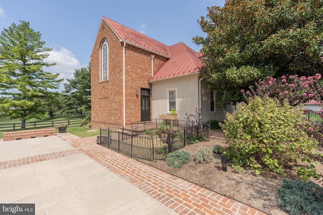 view of side of property with a patio area