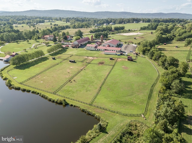 drone / aerial view featuring a rural view and a water and mountain view