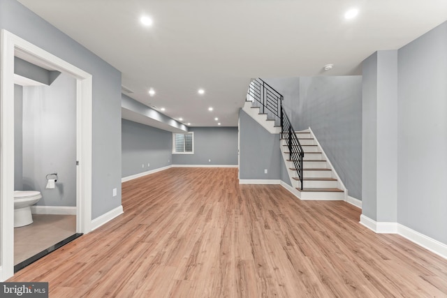 basement with light hardwood / wood-style floors