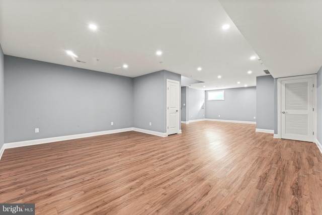 basement with light hardwood / wood-style flooring