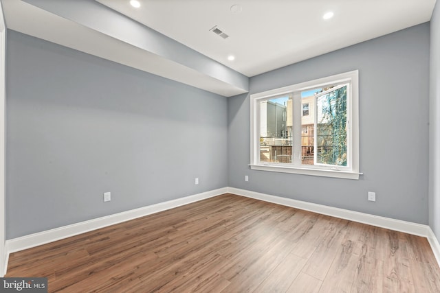 spare room with hardwood / wood-style floors