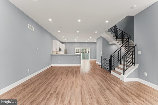 unfurnished living room with light hardwood / wood-style floors