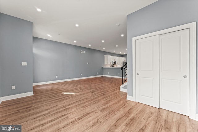 unfurnished living room with light wood-type flooring