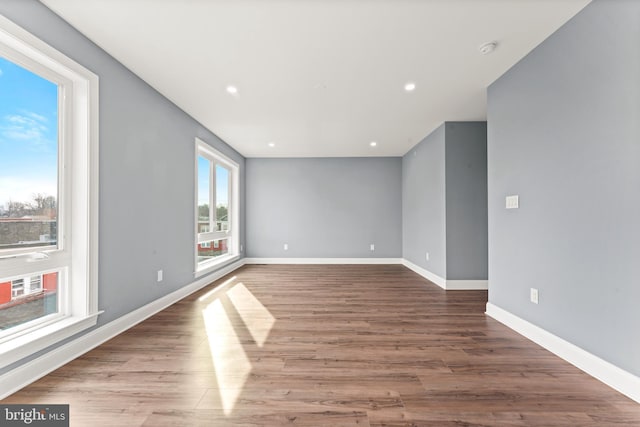 empty room with hardwood / wood-style floors