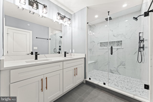 bathroom with tile patterned floors, vanity, and a shower with shower door