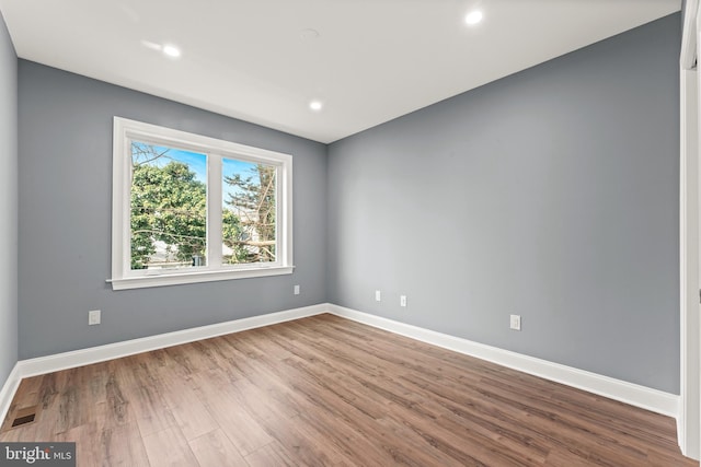 empty room with hardwood / wood-style floors