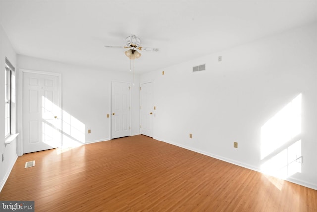 spare room featuring light hardwood / wood-style floors and ceiling fan