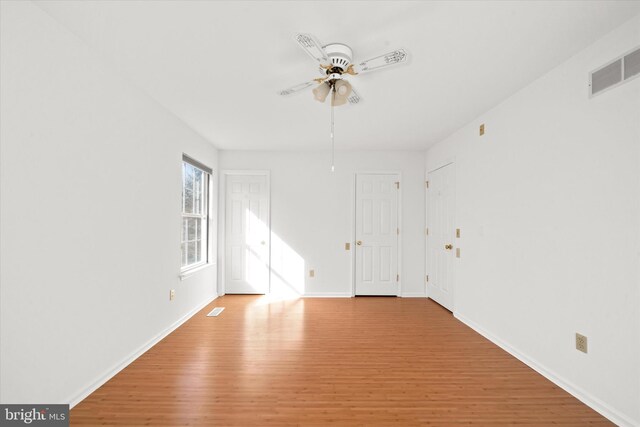 unfurnished room featuring ceiling fan and light wood-type flooring