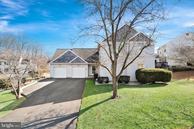 view of front of property featuring a garage and a front lawn