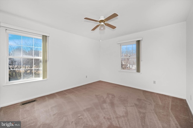 spare room featuring ceiling fan and carpet flooring