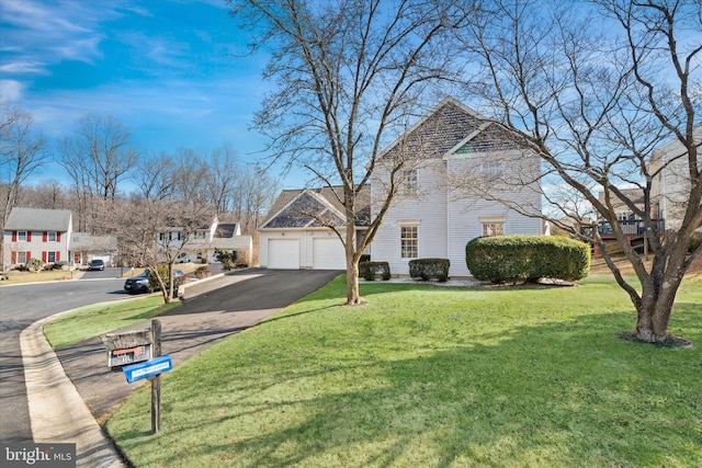 view of front of property with a garage and a front yard