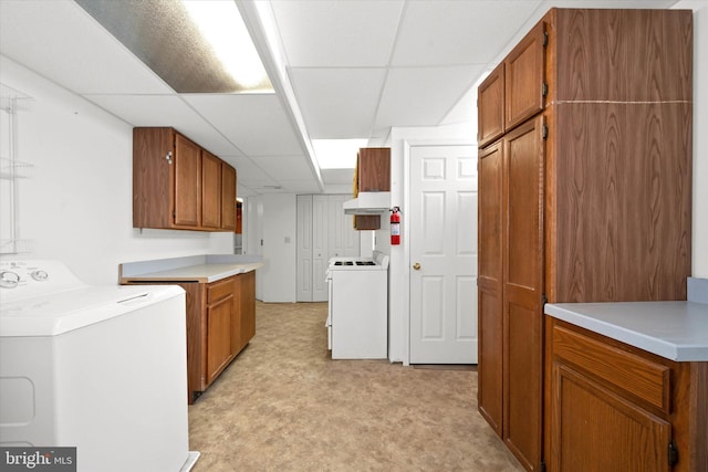 kitchen with a drop ceiling and washer / clothes dryer