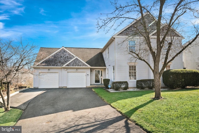 view of front property with a garage and a front lawn