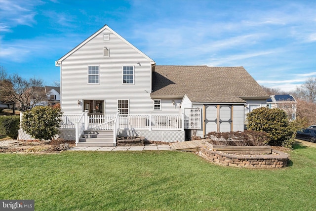 rear view of property with a yard and a deck