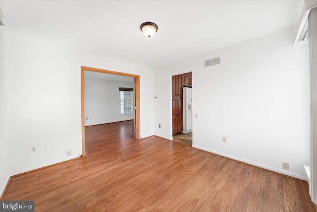 unfurnished room with light hardwood / wood-style floors