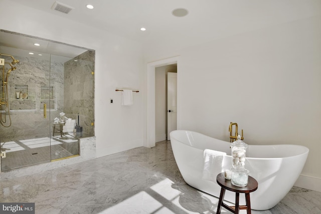 bathroom featuring independent shower and bath