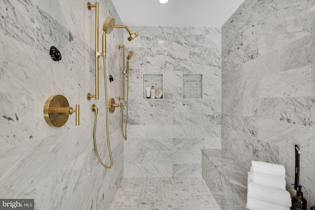 bathroom with tiled shower