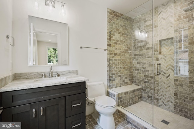 bathroom featuring vanity, an enclosed shower, tile patterned floors, and toilet