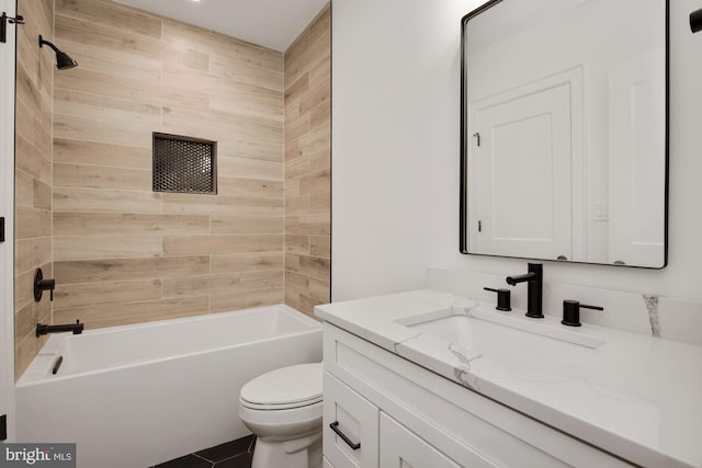 full bathroom featuring vanity, toilet, and tiled shower / bath